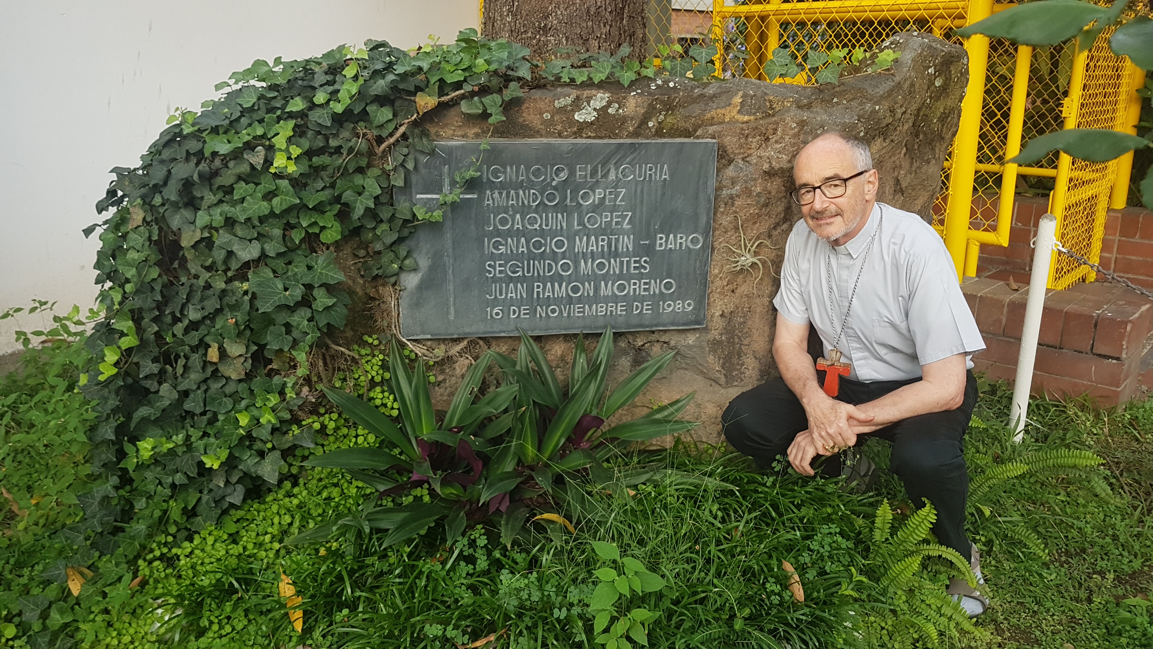 Michael Cardinal Czerny, SJ at the boulder and plaque, and the rose garden, mark where the 6 Jesuit brothers were murdered, while the mother and daughter were murdered in a bedroom a few paces away ... the roses planted by the husband-father who was watchman at the gate that night .