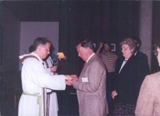 Philip Shano, SJ gives his parents communion at his final vows ceremony. Source: Philip Shano, SJ