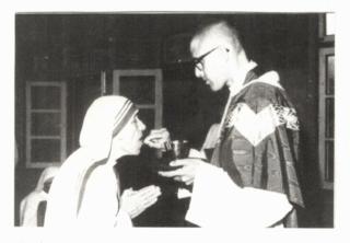1980: Giving communion to Mother Teresa who had come to Kathmandu to open a community.