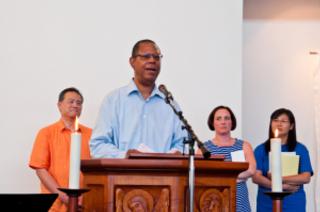 As Georges Gracieuse speaks, Dom Bautista, Catherine Kelly and a member of the Christian life Community look on.