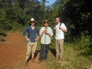 Derek Vo SJ, Andy Froelich JVC, Brook Stacey nSJ trekking through the jungle on their way to Machakhela. 