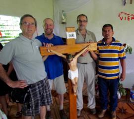 Larry Franz, Casey Whitfield and Fr. Altilia presenting cross to Adrian and La Loma.