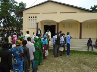 Fr. Christophère, a new Jesuit priest, blesses parishioners after the thanksgiving mass in his hometown. Source: Adam Hincks, SJ
